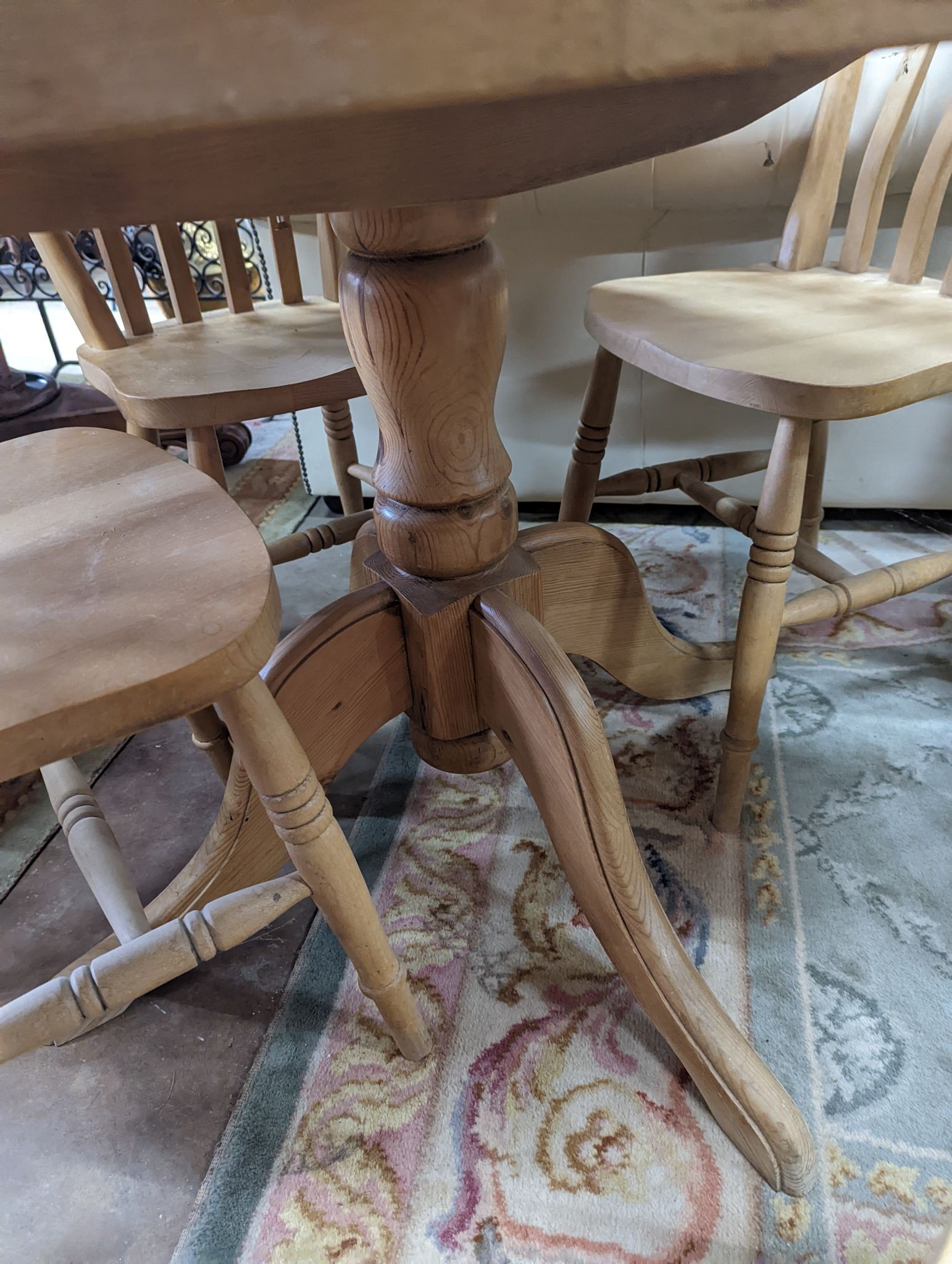 A Victorian style circular pine breakfast table, diameter 105cm, height 74cm, together with four Victorian style beech lathe back kitchen chairs